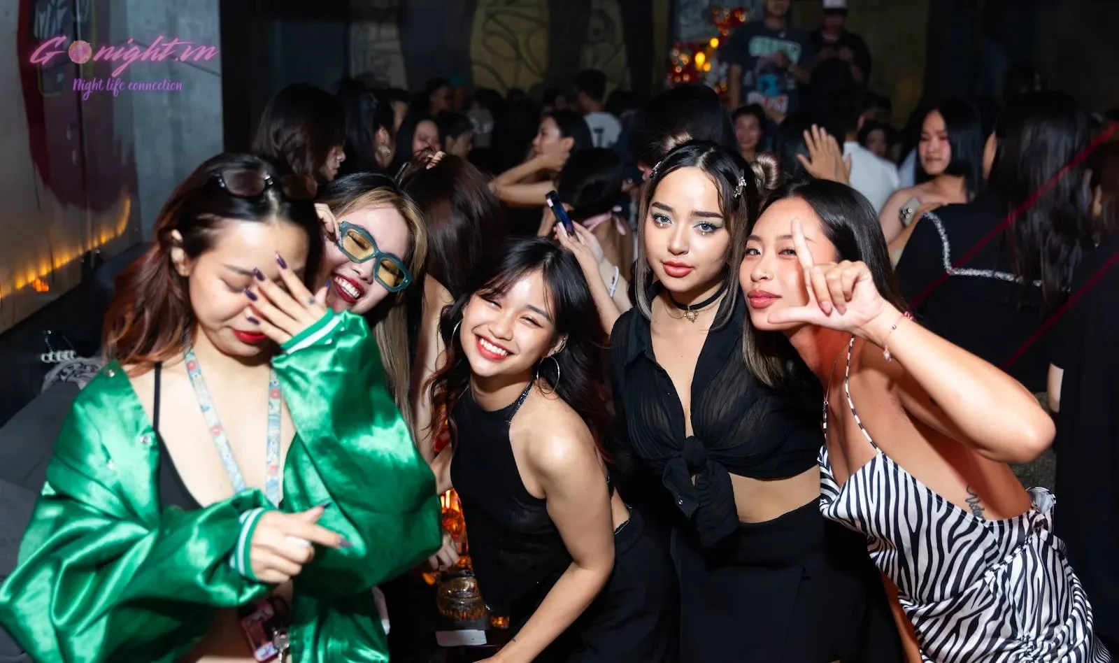Essential Safety Tips for International Travelers in Vietnam 5 Group of friends enjoying a lively night out at a club in Hà Nội, Việt Nam.