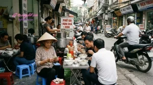 Vibrant street food scene in Hanoi's Old Quarter with locals enjoying Vietnamese cuisine.