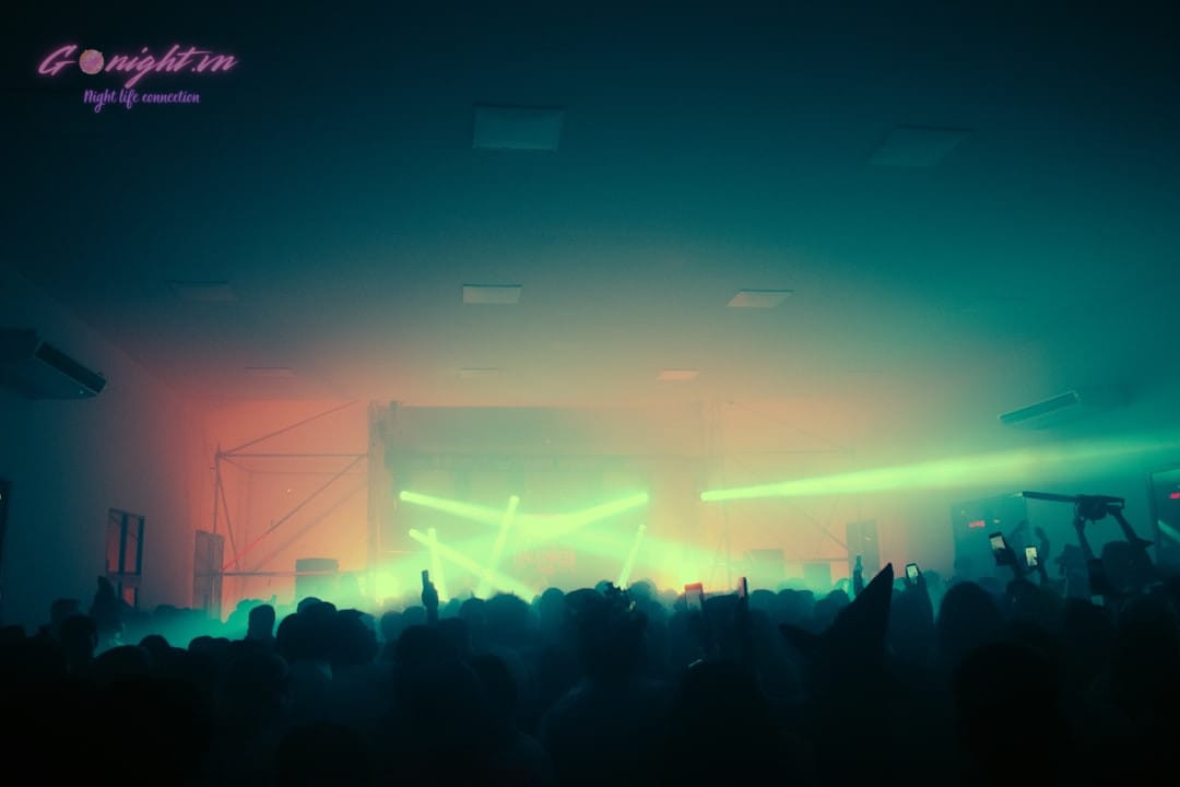 crowded nightclub dance floor with laser lights