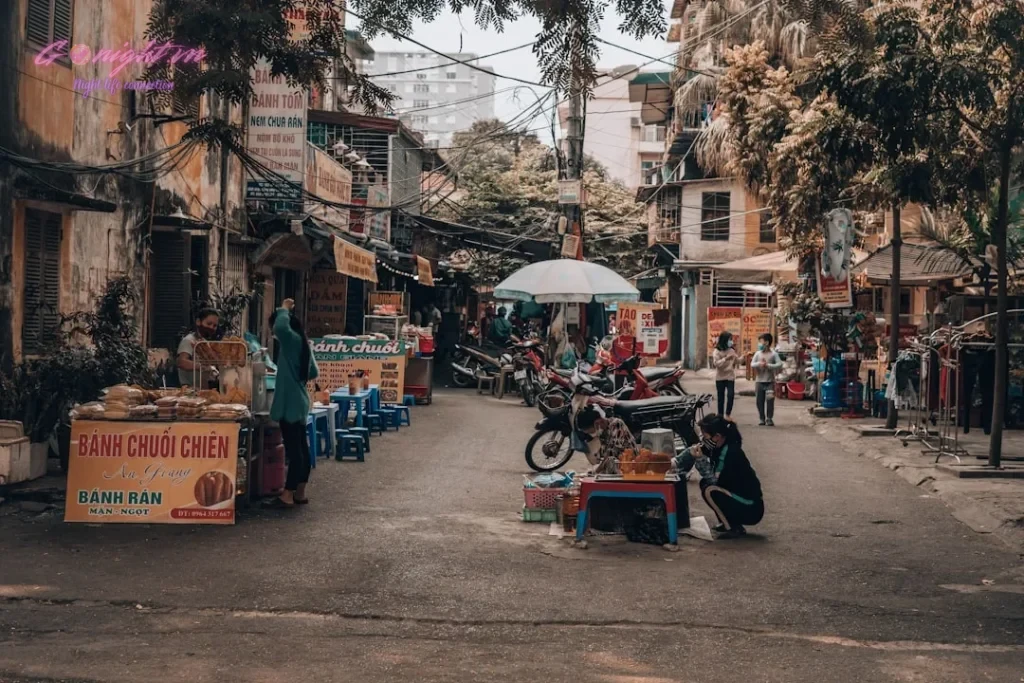 a street scene with people and a motorcycle