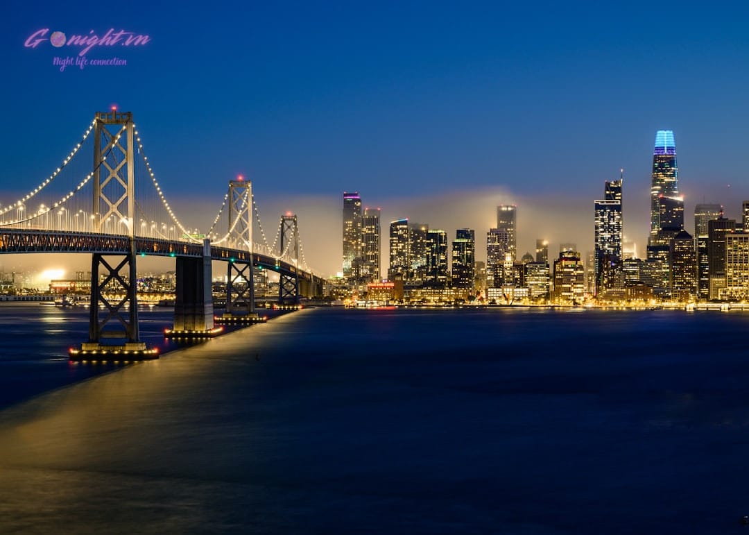 luxury rooftop bar overlooking a bay at night