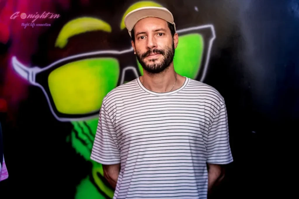 a man standing in front of a colorful wall