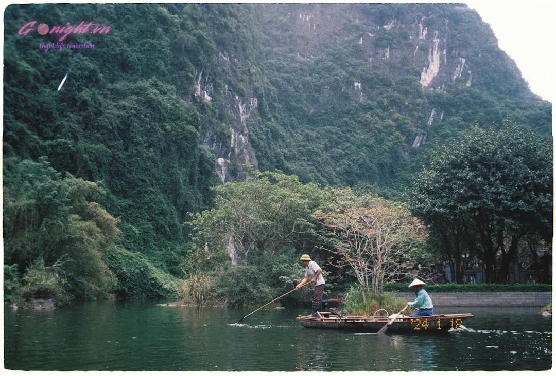 Beyond the Mic: A Comprehensive Guide to Elevating Your Karaoke Experience in Vietnam 4 Two people in a boat on a river