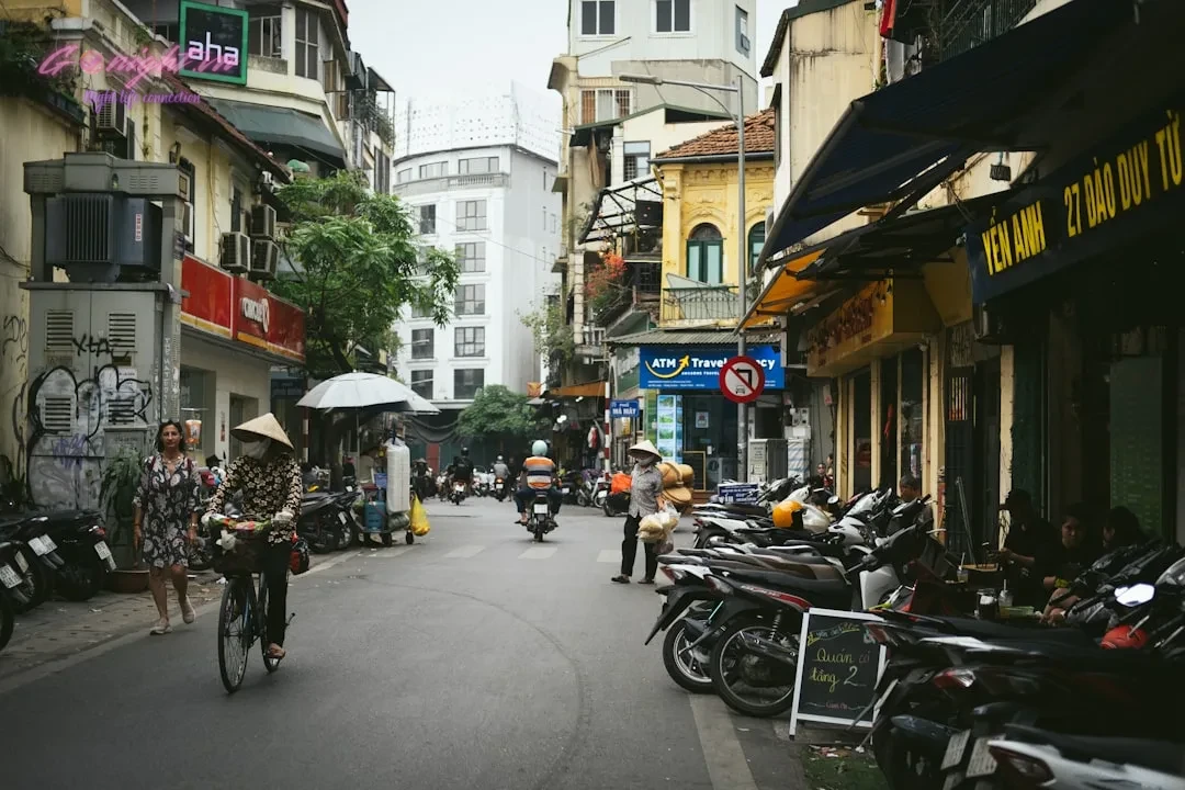 A group of people riding bikes down a street