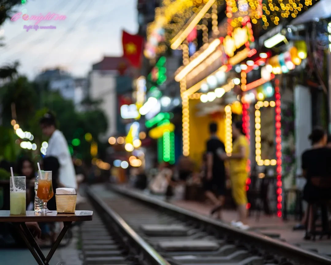 Hanoi's Heartbeat After Dark: An Insider's Guide to the Best Bars & Clubs in the Old Quarter 11 Blurred street scene with people and illuminated buildings