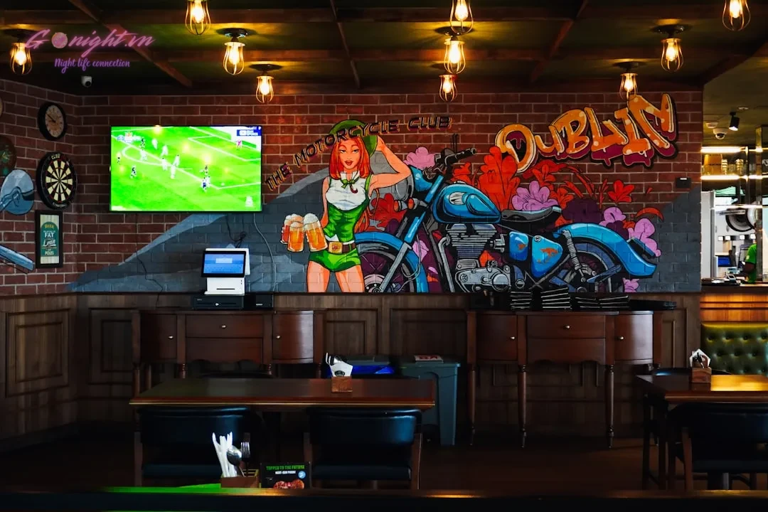 Irish pub interior with motorcycle mural and television.