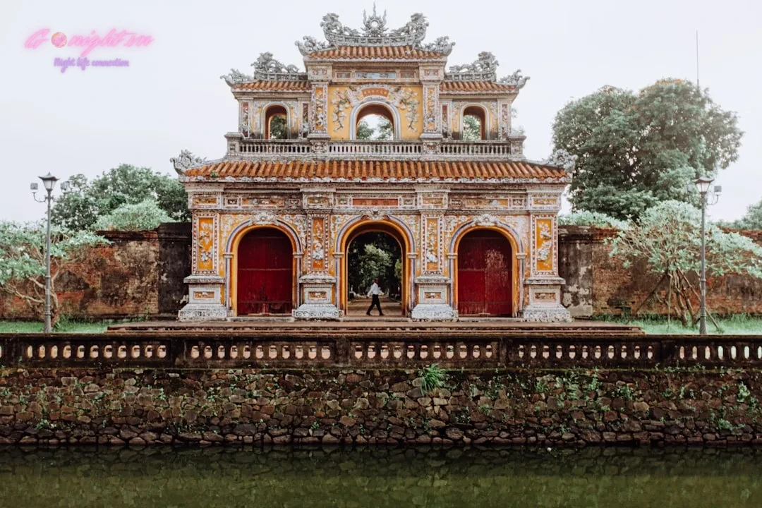 An ornate, traditional vietnamese gate stands tall.