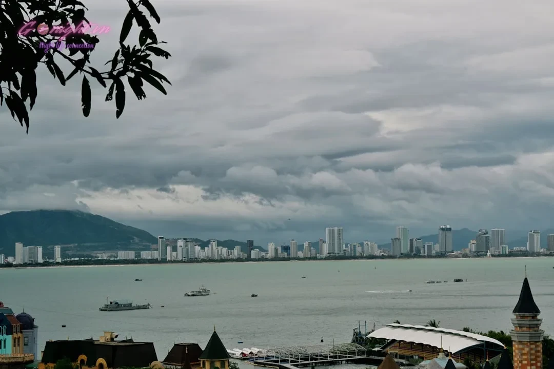 City skyline across the water under cloudy sky