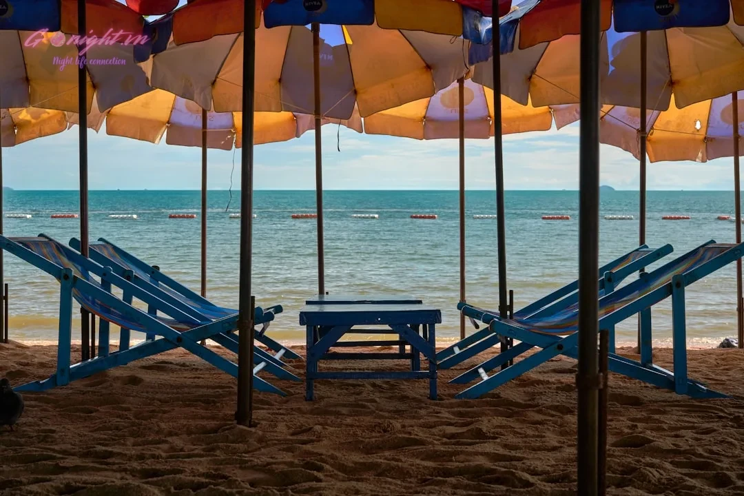 a bunch of umbrellas that are on a beach