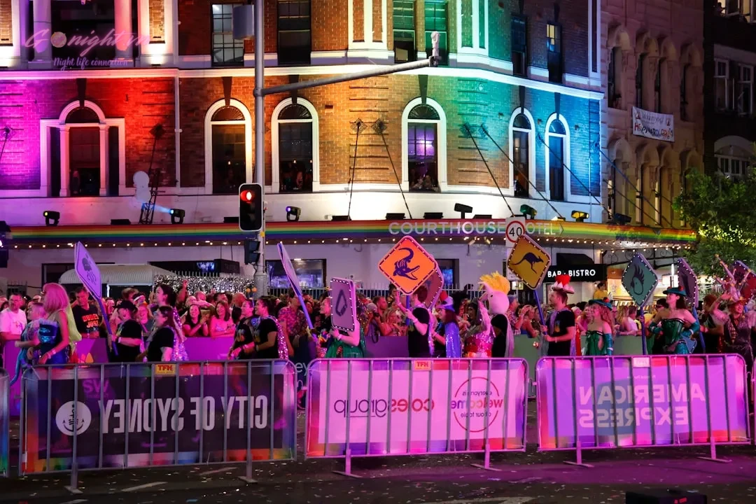 Crowd celebrating at a vibrant city festival at night
