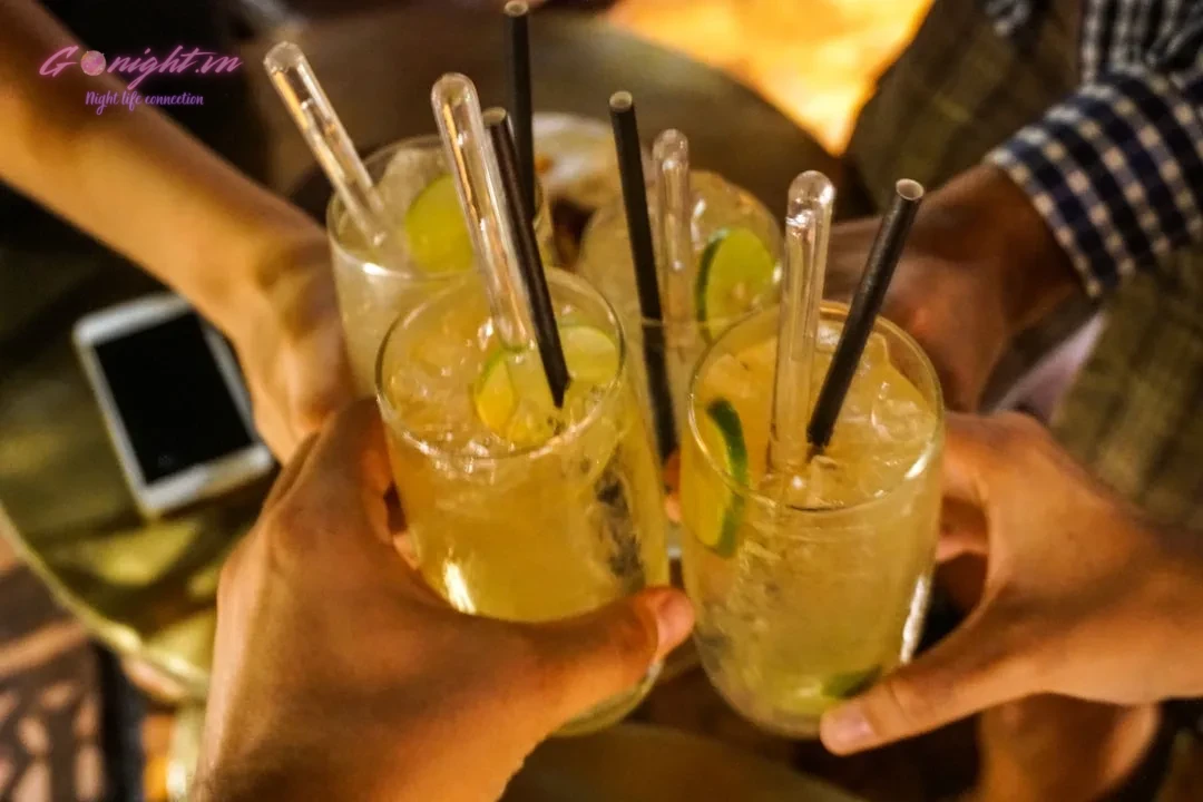 A group of people holding glasses filled with drinks