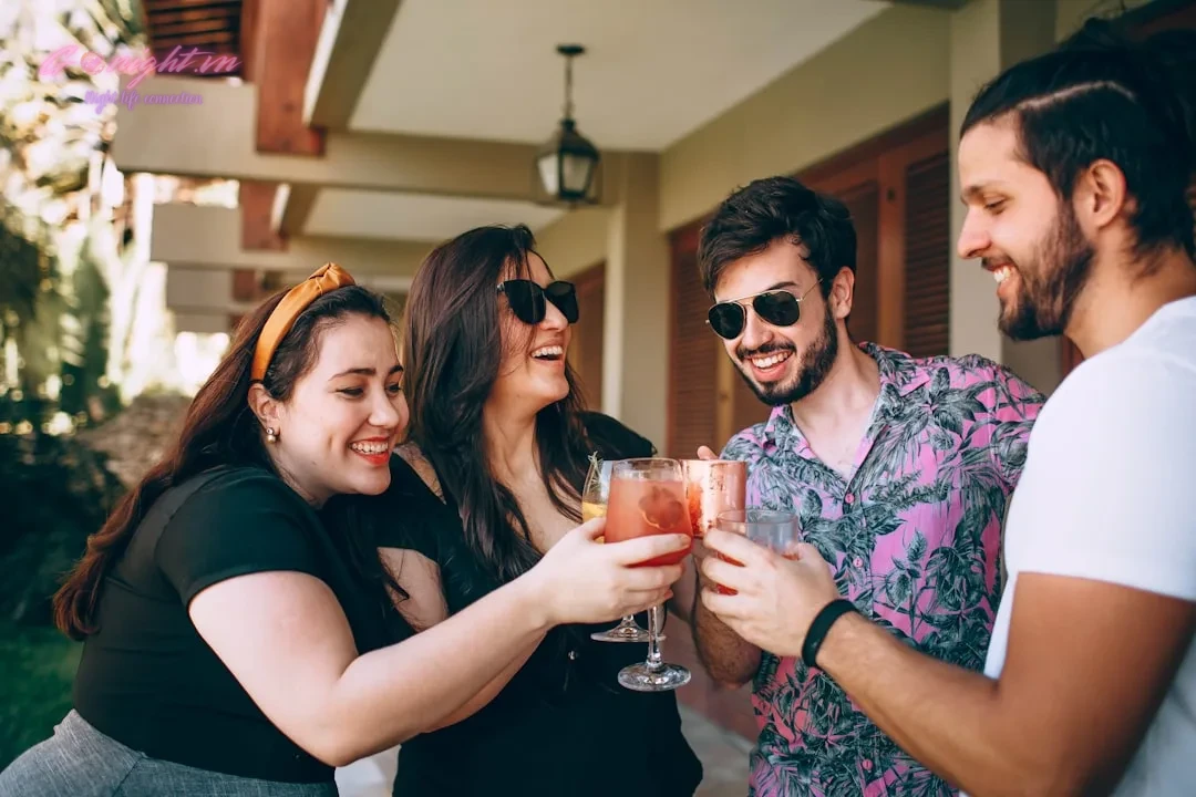 woman in black shirt holding drinking glass