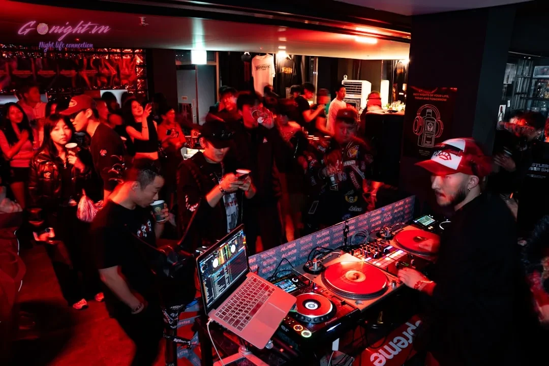 Dj performing for a crowd at a nightclub
