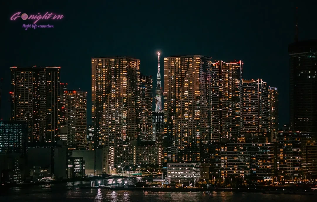 A night view of a city with a lot of tall buildings