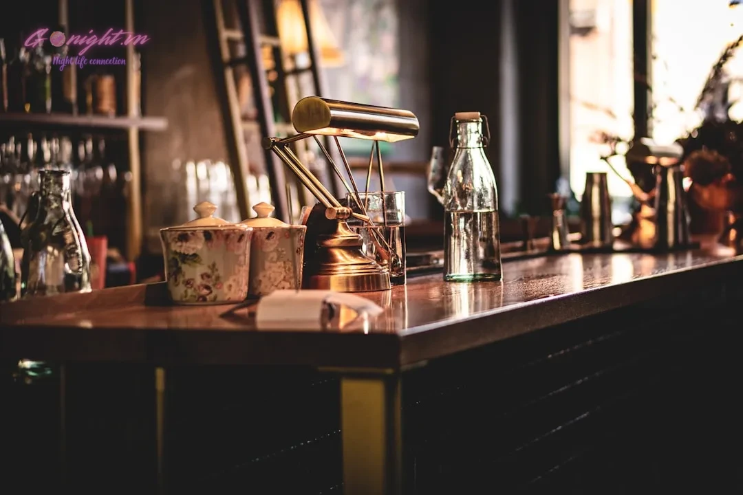clear glass bottle on brown wooden table