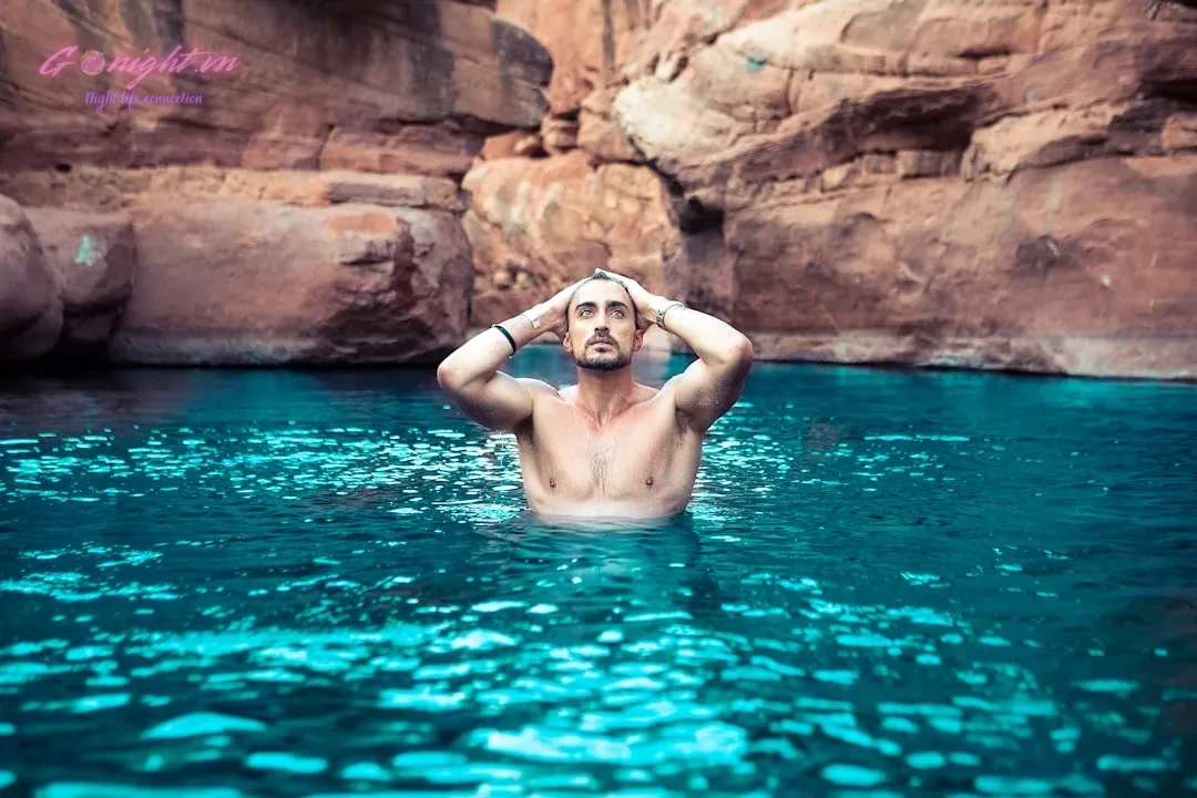 topless man on body of water