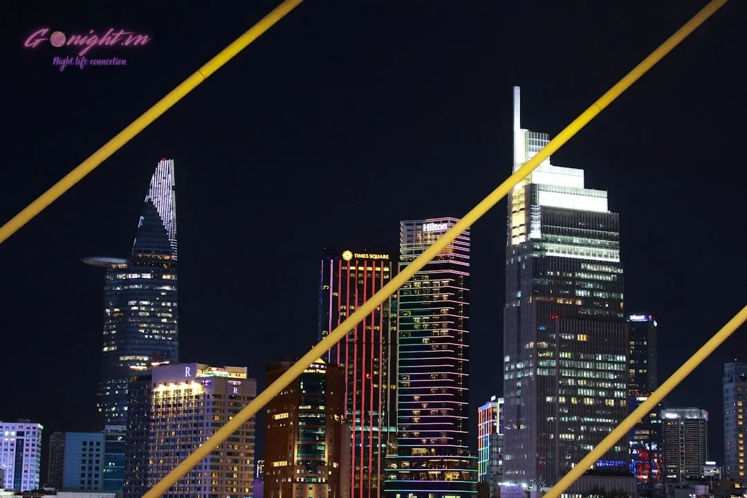 Ho Chi Minh City's Sky-High Escapes: Top 7 Rooftop Bars with Breathtaking Views 7 A view of a city at night from across the water