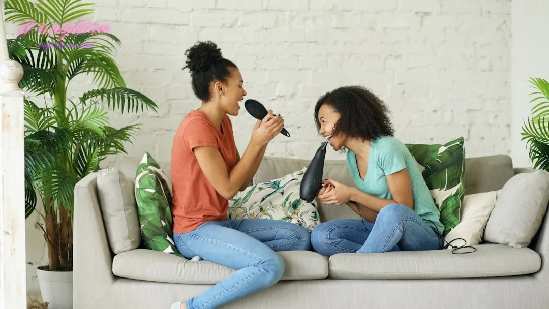Beyond the Mic: A Comprehensive Guide to Elevating Your Karaoke Experience in Vietnam 11 Two women singing into hairbrushes on a couch.