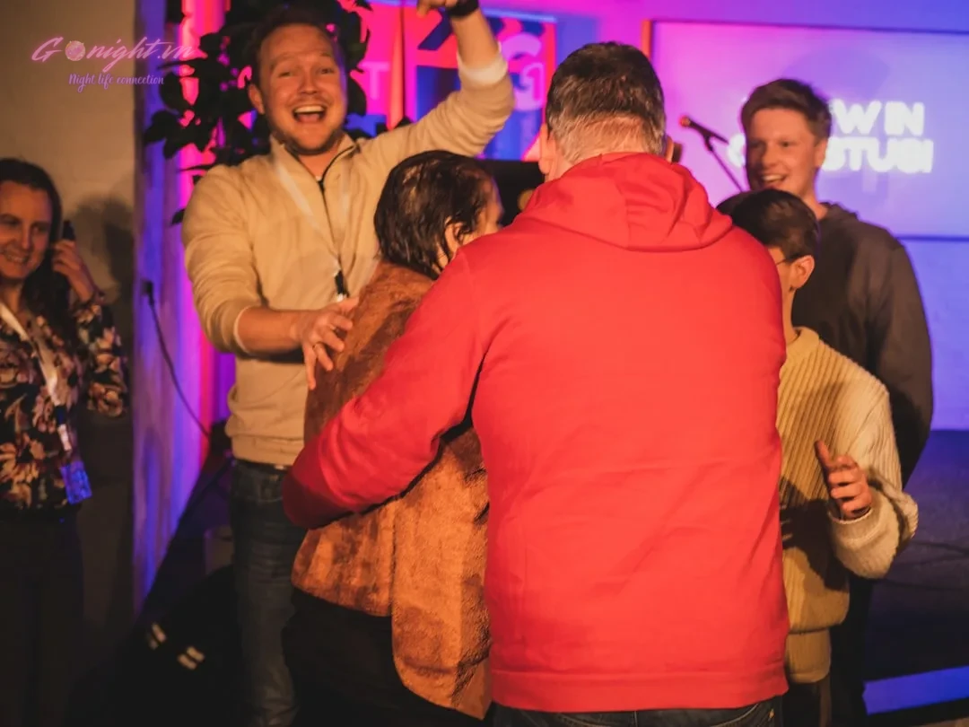 A group of people standing around each other