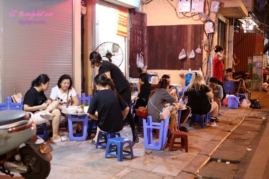 Beyond the Mic: A Comprehensive Guide to Elevating Your Karaoke Experience in Vietnam 1 a group of people sitting around a blue table