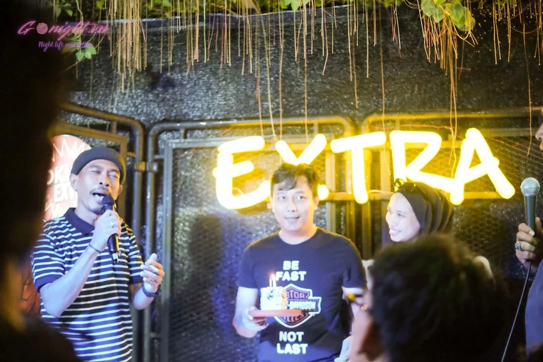 Bac Ninh's Nightlife Uncovered: A Guide to the Top 10 Karaoke Venues for an Epic Sing-Off 11 a group of people standing in front of a neon sign