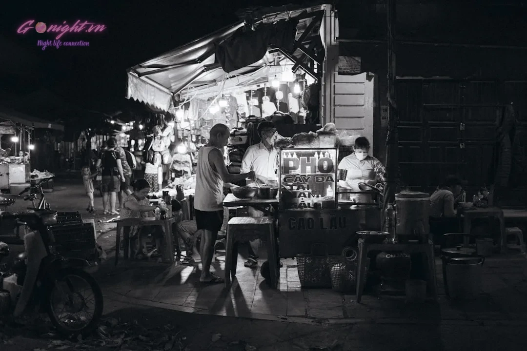 A black and white photo of a night market