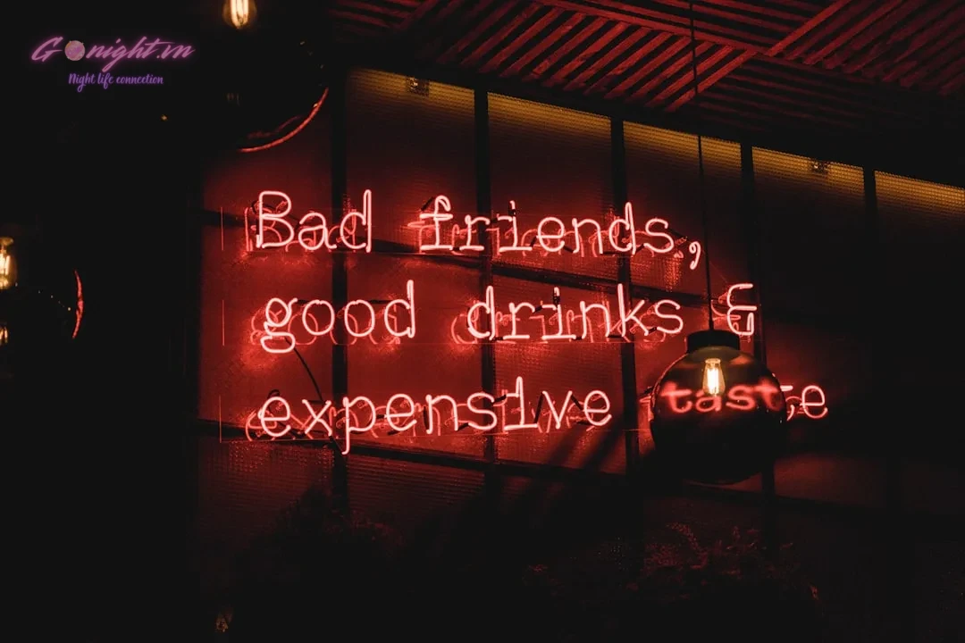 bad friends, good drinks & expensive taste neon sign on wall