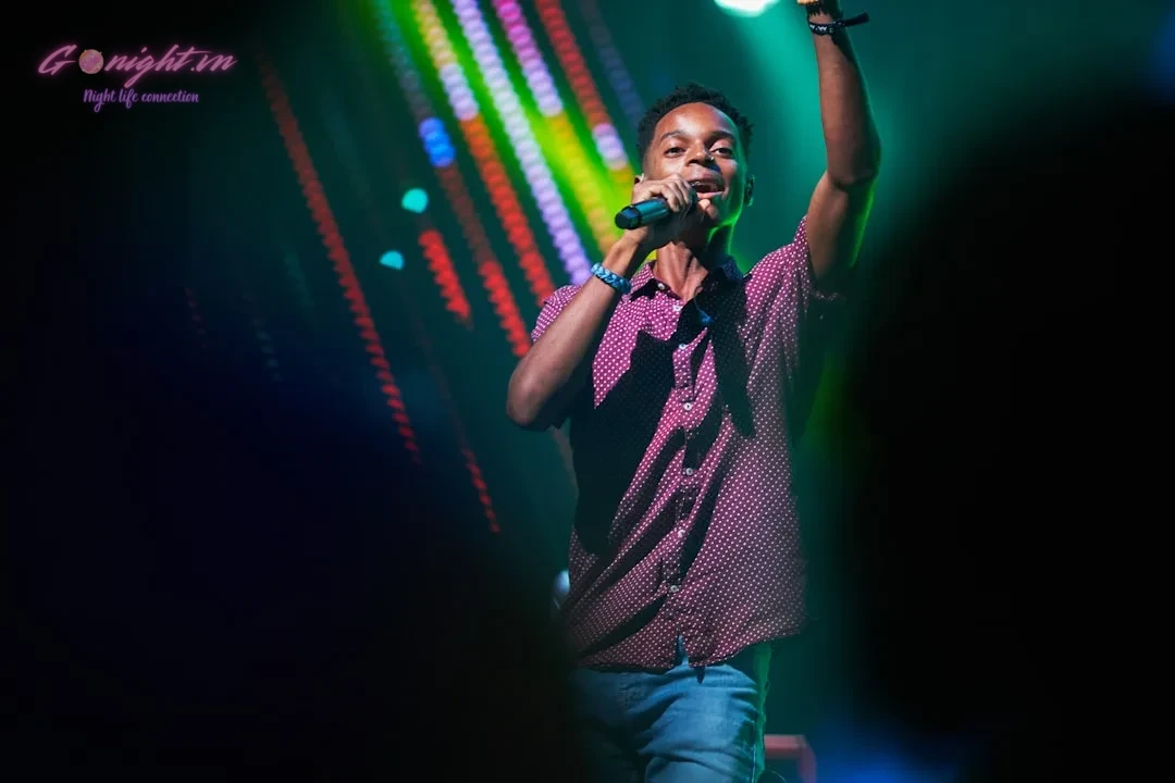 Unleash Your Inner Pop Star: Top 7 Karaoke Venues in Binh Duong for an Unforgettable Singing Experience 1 man in black and white polka dot button up shirt singing
