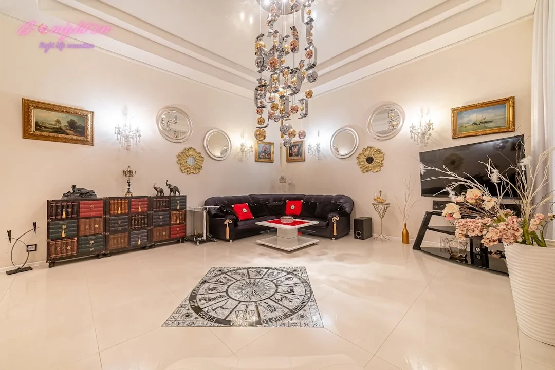 a living room filled with furniture and a chandelier