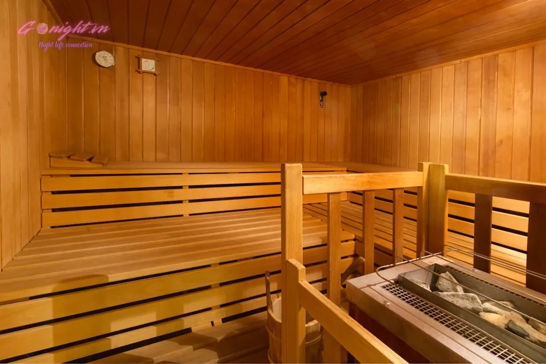 Interior of a clean, empty wooden sauna with benches.