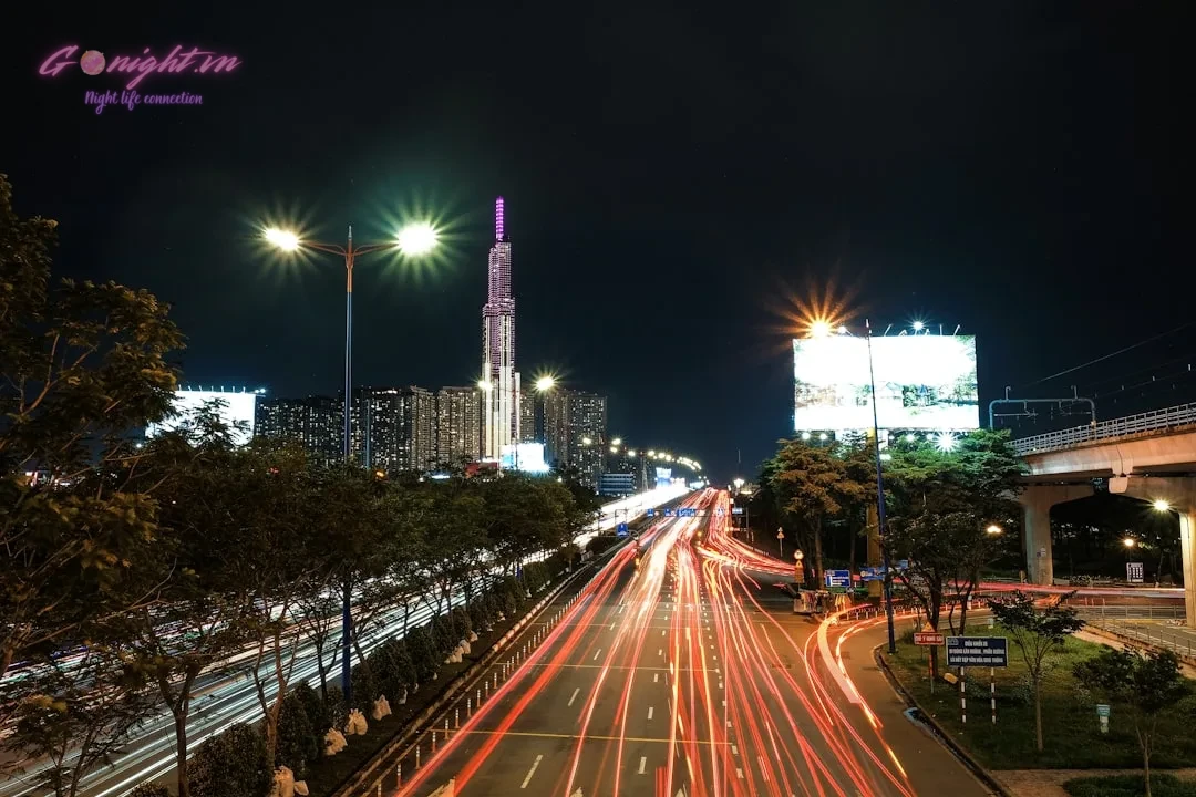 Review Chi Tiết Boujee Saigon Club: Trải Nghiệm Giải Trí Đẳng Cấp và Phong Cách Độc Đáo Tại Trung Tâm Sài Gòn 2 Cityscape with light trails on highway at night