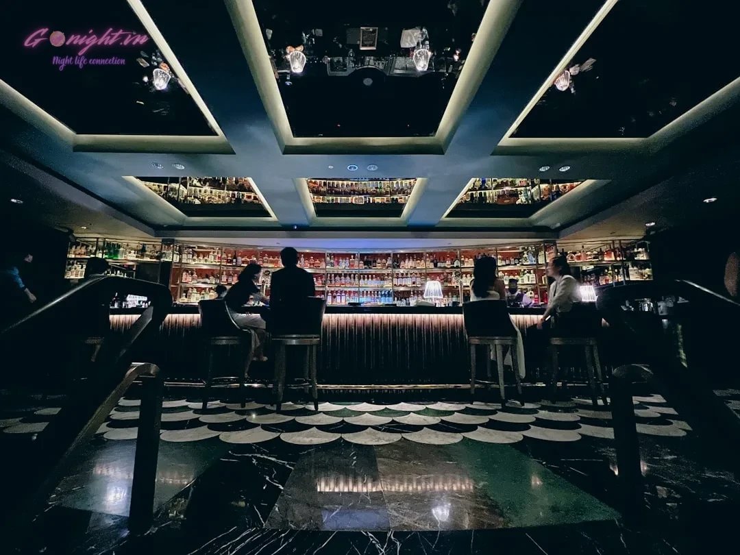 a group of people sitting at a bar