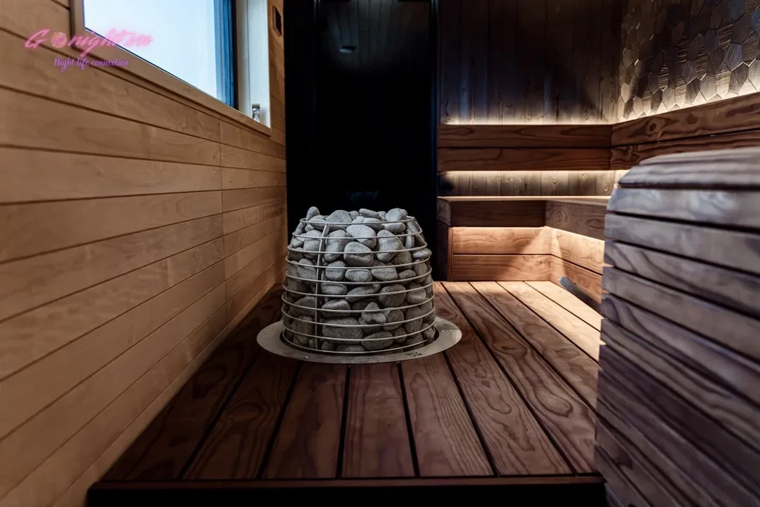 Interior of a modern wooden sauna with stone heater.
