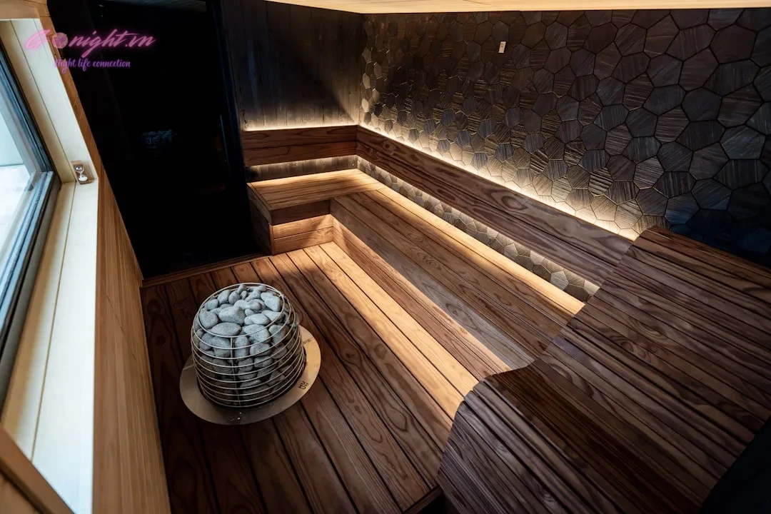 Modern wooden sauna with stone heater and ambient lighting