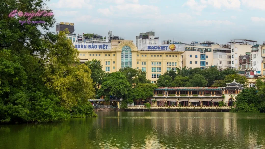 City buildings are seen across a lake.
