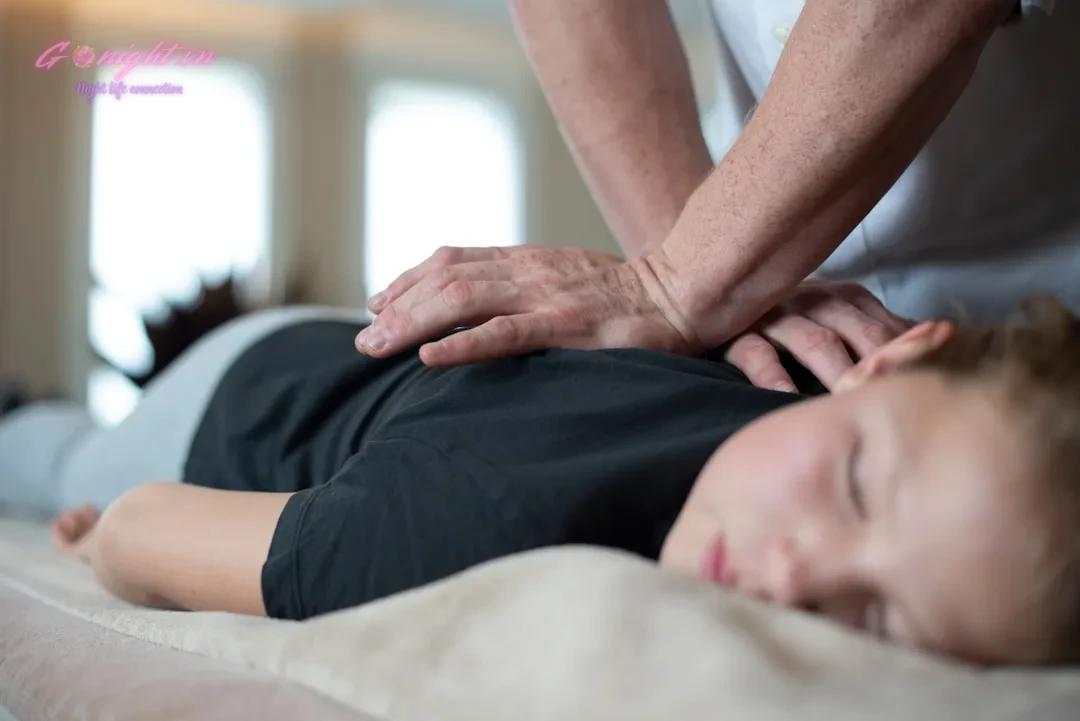 a woman getting a back massage from a man
