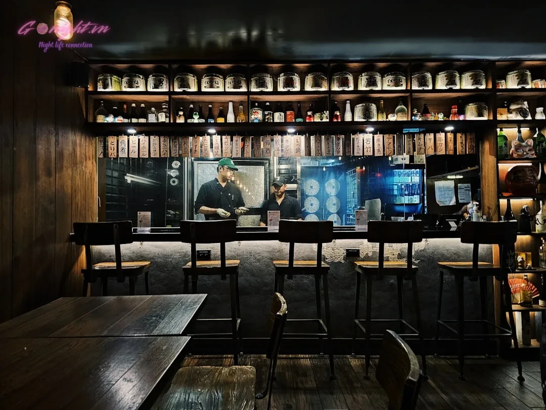 a bar with a lot of bottles on the shelves