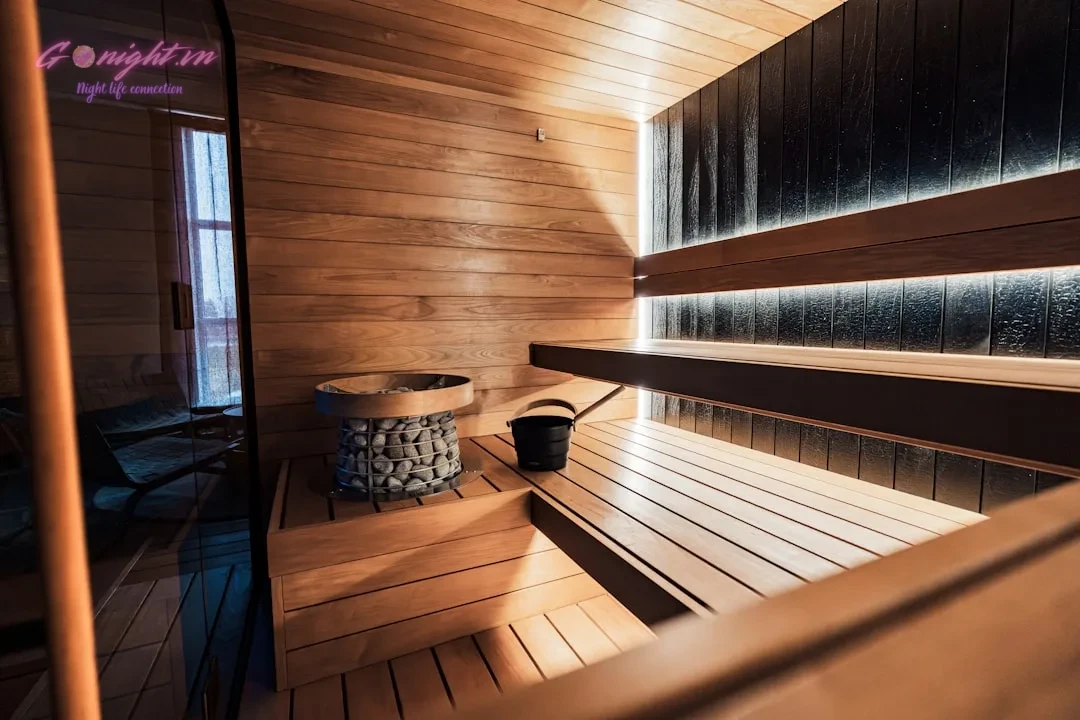 Khám Phá Top 5 Địa Điểm Massage Làng Việt Kiều Châu Âu Thư Giãn Đỉnh Cao 5 Interior of a modern wooden sauna with stone heater.