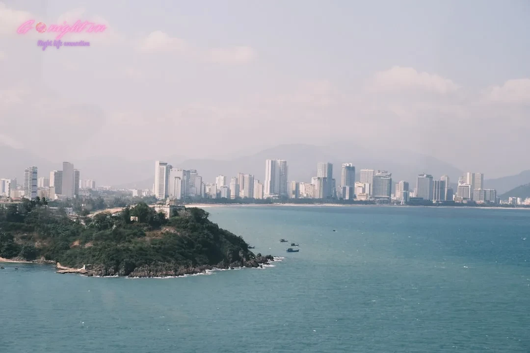 a large body of water with a city in the background