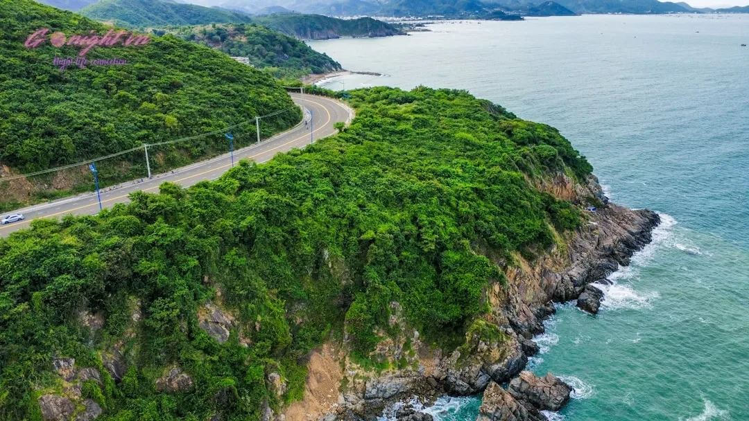 An aerial view of a road on a cliff overlooking the ocean