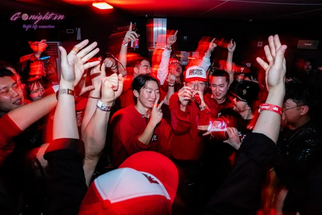 A group of people dancing with hands in air.