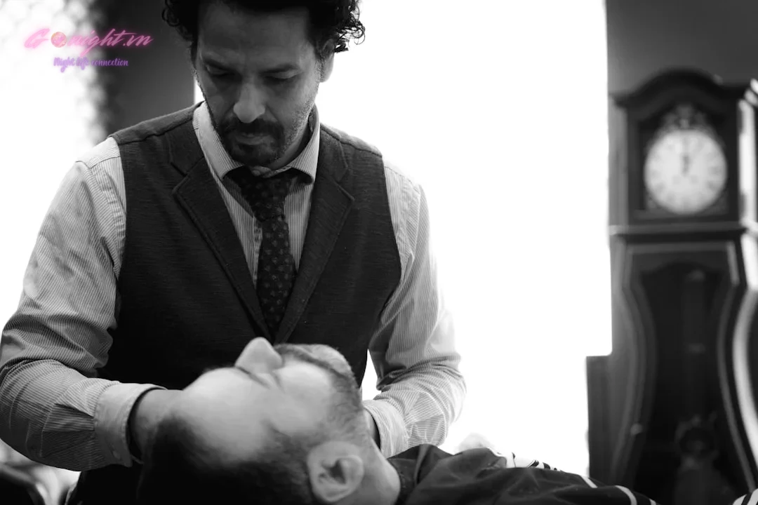 A man getting his hair cut by a barber