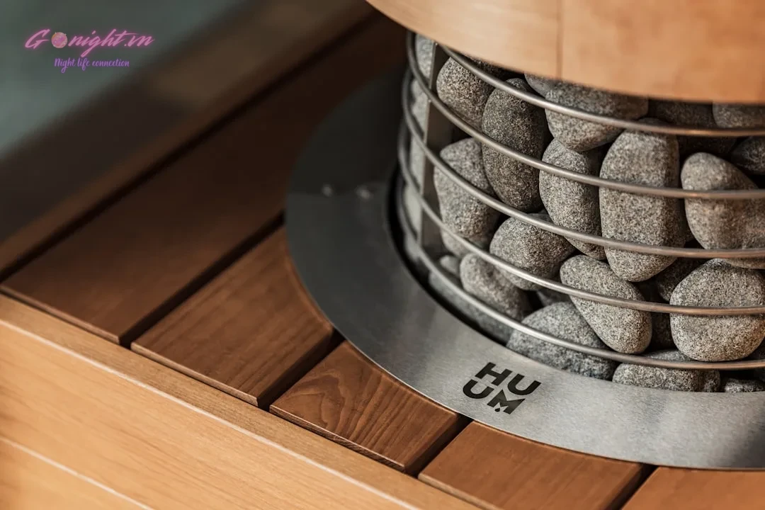 Close-up of a sauna heater with stones and wood