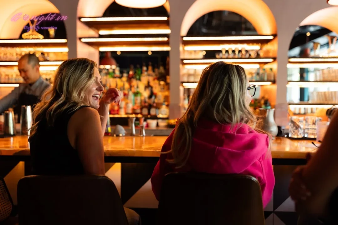 A group of people sitting at a bar