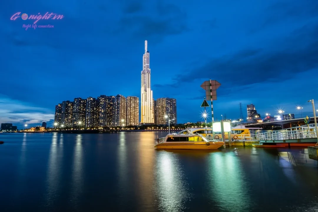 Quẩy Xuyên Màn Đêm: Khám Phá Top 7 Club & Bar Sôi Động Bậc Nhất Quận 1, Sài Gòn 1 city skyline across body of water during night time