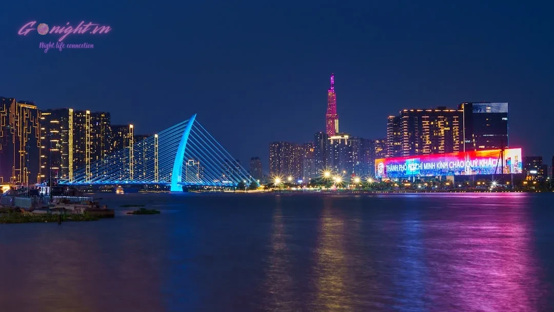 Night cityscape with bright lights reflected in the water.