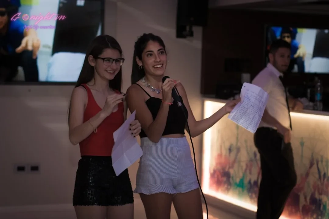 Top 7 Quán Karaoke 'Hát Là Mê' Tại Bình Dương: Điểm Hẹn Giải Trí Bất Tận Cho Mọi Cuộc Vui! 9 Three women standing in a room with a television in the background