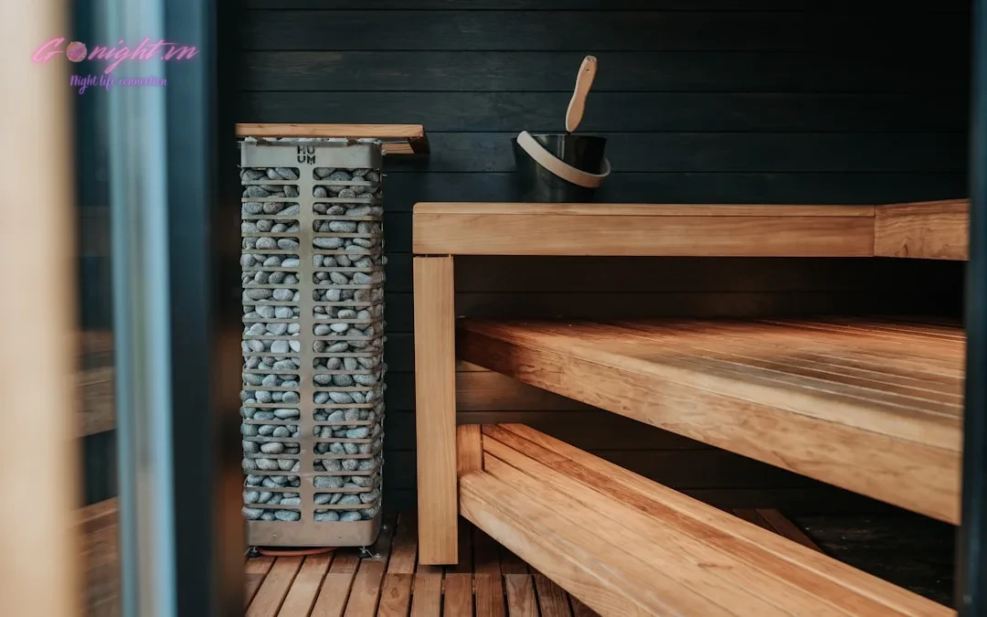 Interior of a modern wooden sauna with stone heater.