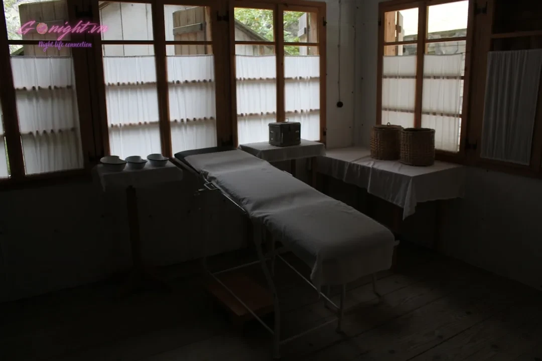 Bảng Giá Massage Bình Dương: Top Địa Điểm Thư Giãn Đẳng Cấp Nhất 1 a room with several windows and a table in it