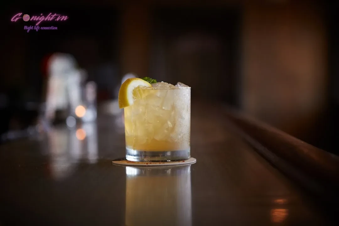 clear drinking glass with yellow liquid and sliced lemon